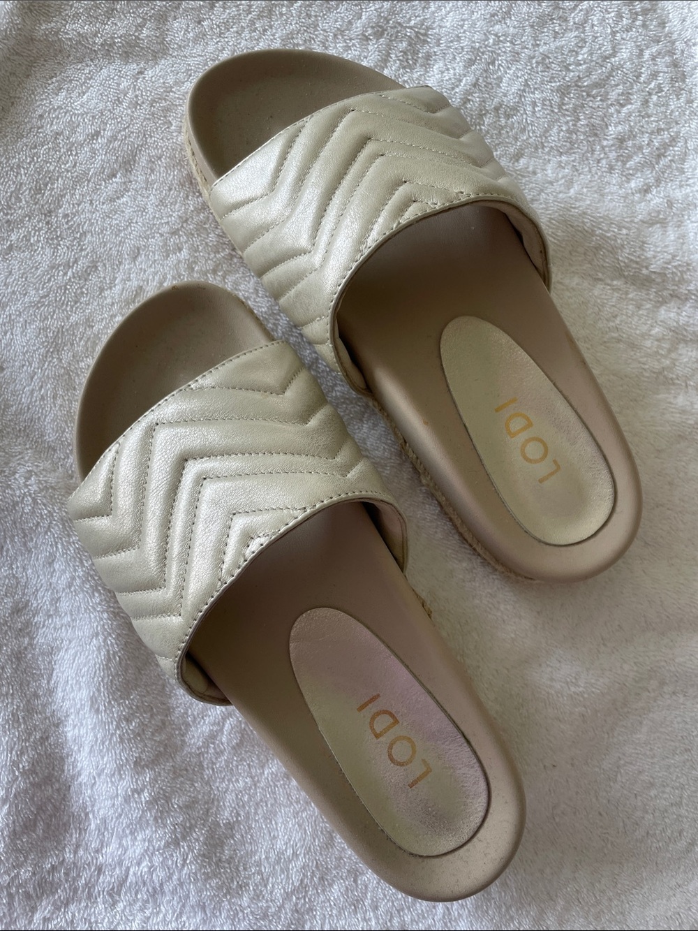 LODI, Metallic Gold Quilted Slide Sandals with Espadrille Detail on Sole.
